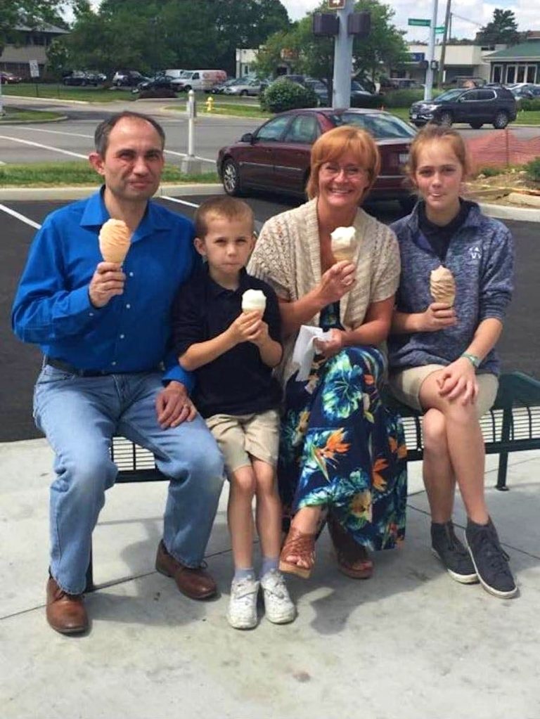 This woman offered to photograph a joyful family who had gone out for ice cream together.