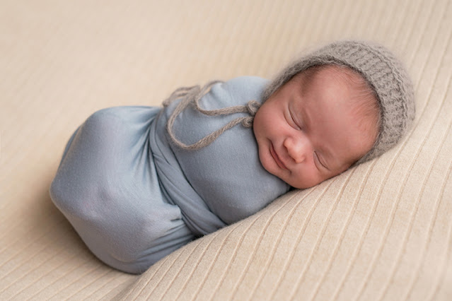 Why do babies smile as they sleep?