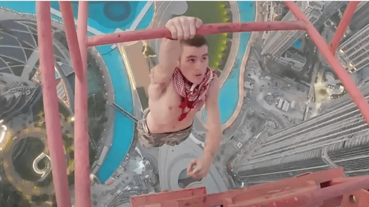 After scaling 1,200 feet above Dubai, a free climber notices that the crane is covered with grease.