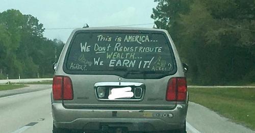 A message displayed prominently on the back of an SUV has ignited a spirited discussion online after rapidly spreading across the internet. The phrase, in bold letters on the vehicle's rear window, stated:

“This is America… we don’t redistribute wealth… we earn it!”

The photo, initially shared by a user on Reddit with the caption, “Saw this patriot while driving,” quickly caught the attention of many, prompting a lively exchange of views on its meaning. Some lauded the driver for expressing a strong belief in personal accountability and the wholesome value of hard work.